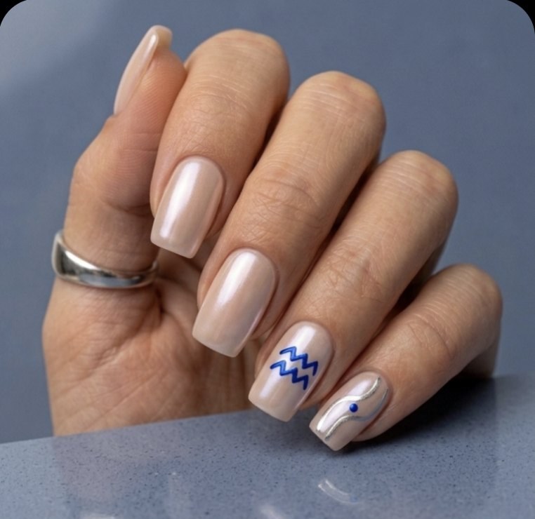 Minimal Aquarius manicure with pearl-chrome squoval nails, liquid silver twin waves, Aquarius glyph and electric cobalt accent.