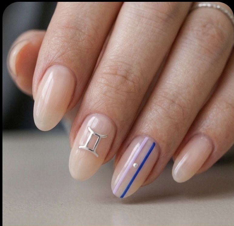 Minimal Gemini manicure with sheer blush oval nails, polished silver twin lines, Gemini glyph, lilac and cobalt details.