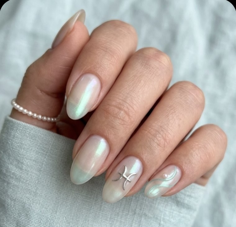 Minimal Pisces manicure with translucent opal rounded-almond nails, liquid silver flow lines, Pisces glyph and sea-glass curves.