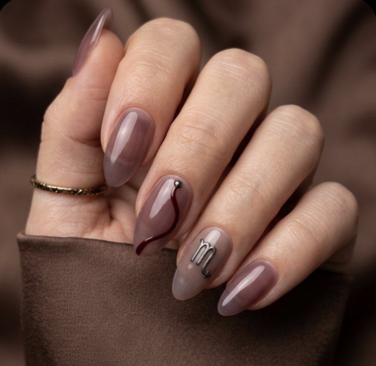 Minimal Scorpio manicure with smoky plum almond nails, fine gunmetal shine, Scorpio glyph and a hidden dark garnet detail.